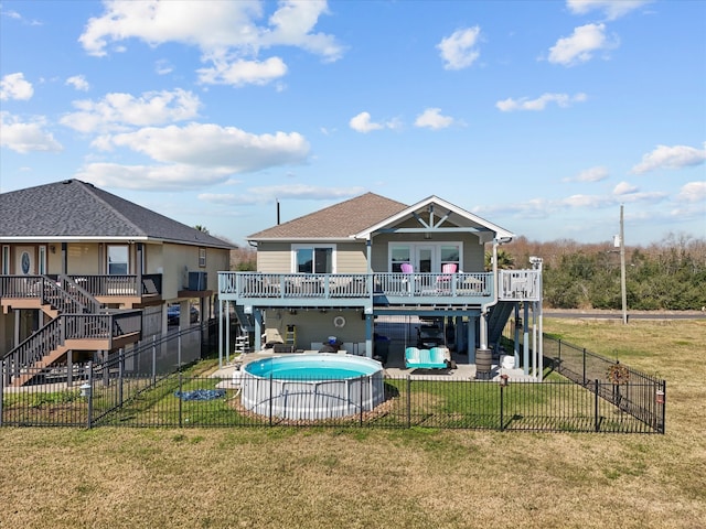 rear view of property with a fenced backyard, a lawn, stairway, and a patio