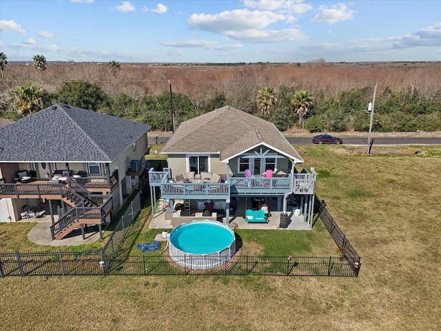 back of property with a fenced backyard, stairs, a deck, a yard, and a patio area