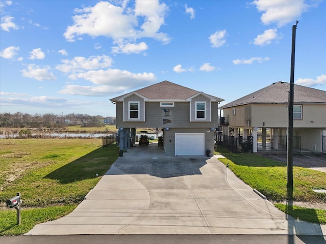 coastal inspired home featuring an attached garage, fence, driveway, a carport, and a front lawn