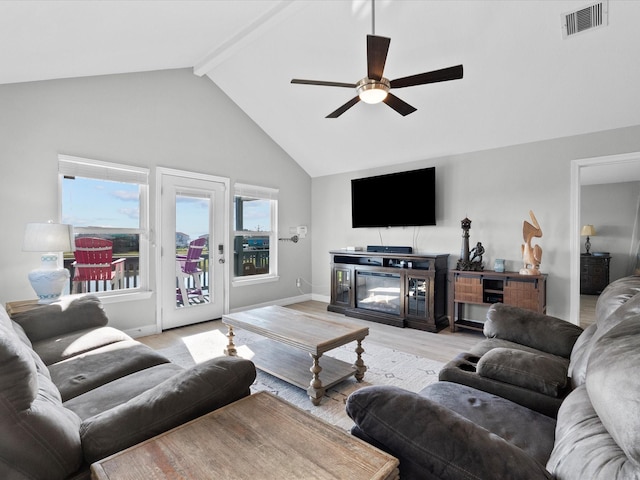 living room with baseboards, visible vents, light wood-style flooring, ceiling fan, and beamed ceiling