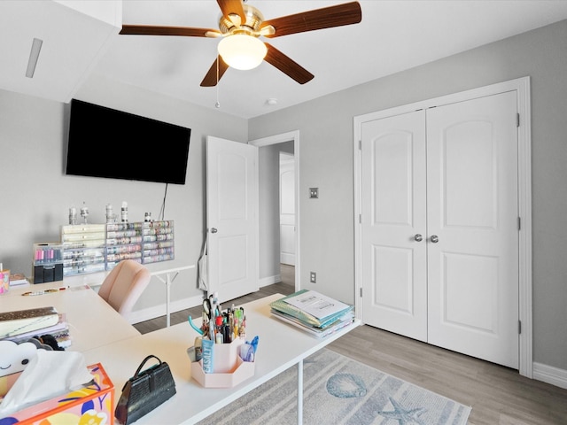 office space with ceiling fan, wood finished floors, and baseboards