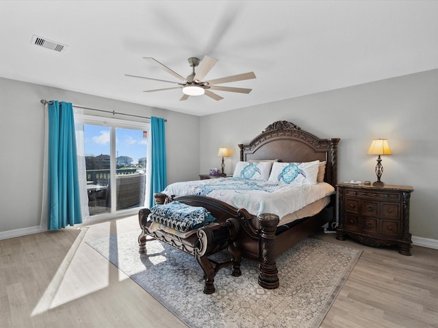 bedroom with ceiling fan, wood finished floors, visible vents, baseboards, and access to exterior