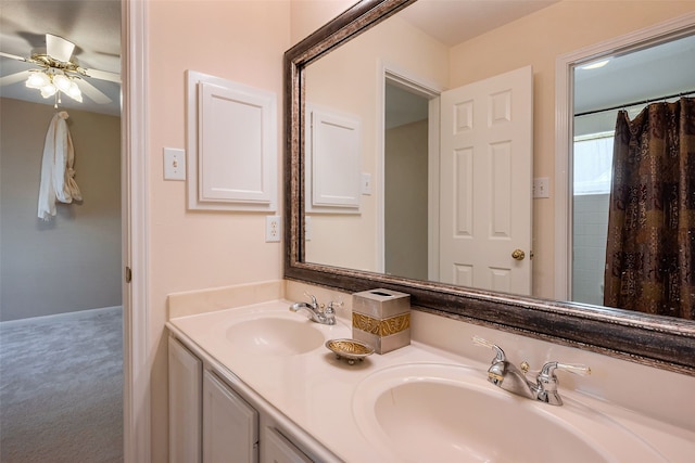 full bath with ceiling fan, double vanity, and a sink