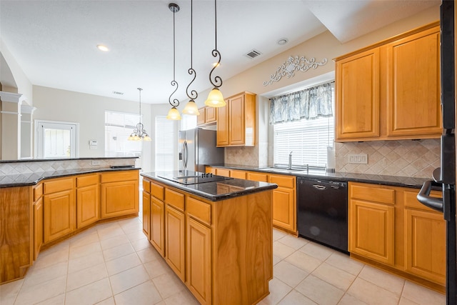 kitchen with black appliances, light tile patterned floors, decorative backsplash, and a center island