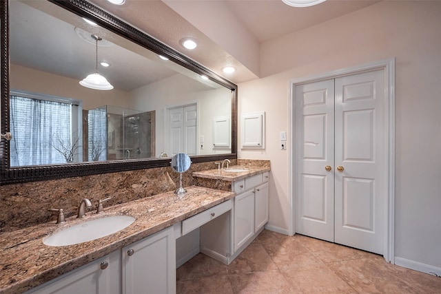 bathroom featuring a closet, a shower stall, vanity, baseboards, and tile patterned floors