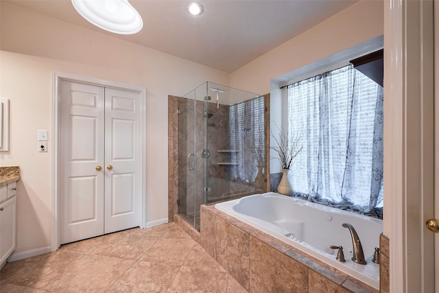 bathroom with a garden tub, a shower stall, baseboards, and vanity