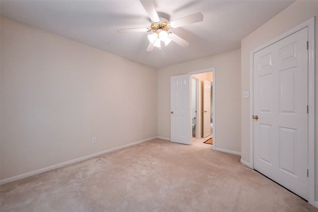 unfurnished bedroom with ceiling fan, baseboards, and light colored carpet