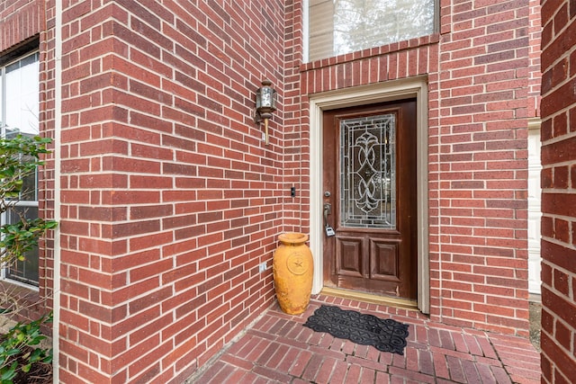 entrance to property with brick siding