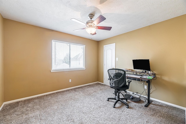 carpeted home office featuring a ceiling fan, a textured ceiling, and baseboards