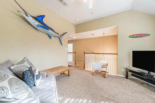 interior space featuring carpet floors, visible vents, a ceiling fan, vaulted ceiling, and baseboards