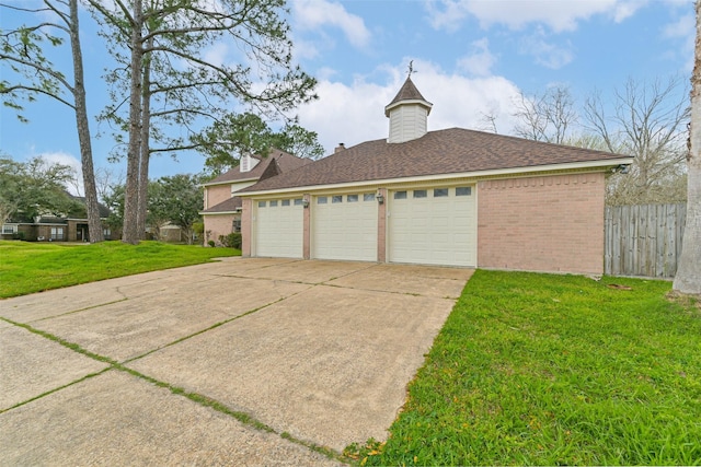 garage featuring driveway and fence