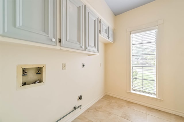 washroom with hookup for an electric dryer, gas dryer hookup, hookup for a washing machine, and a wealth of natural light
