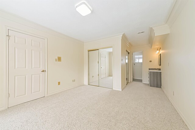 unfurnished bedroom featuring ornamental molding, visible vents, light carpet, and baseboards