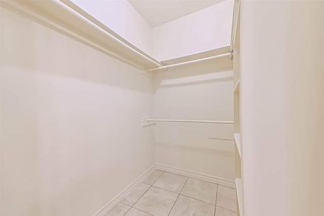 spacious closet featuring light tile patterned floors