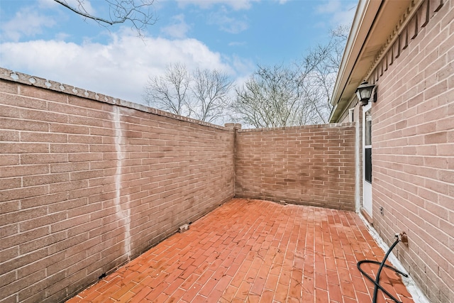 view of patio / terrace featuring fence