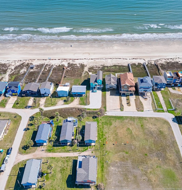 bird's eye view with a residential view, a water view, and a beach view