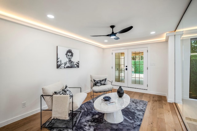 living area featuring recessed lighting, baseboards, wood finished floors, and french doors