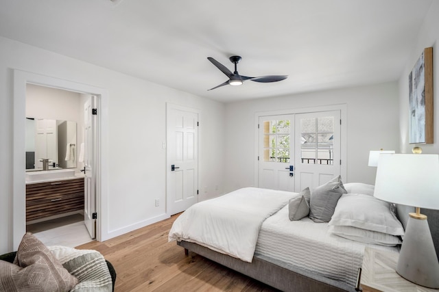 bedroom featuring baseboards, ceiling fan, ensuite bathroom, and light wood-style floors