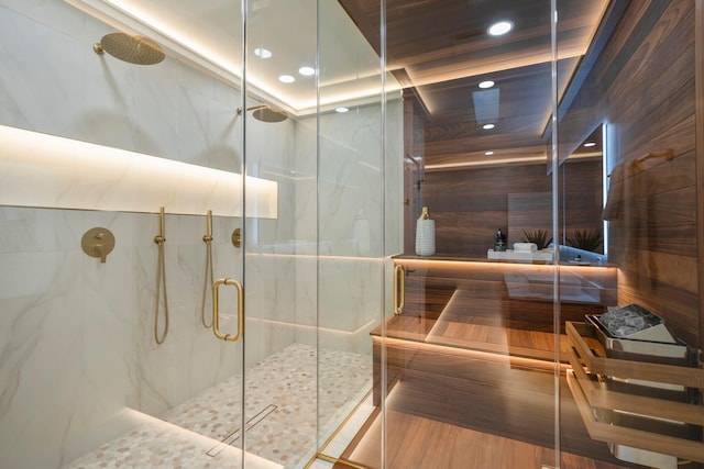 bathroom featuring recessed lighting and a marble finish shower