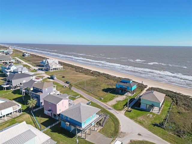 aerial view with a water view, a residential view, and a view of the beach