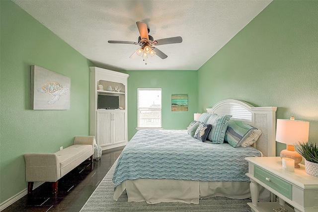 bedroom with a textured ceiling, ceiling fan, a textured wall, and baseboards