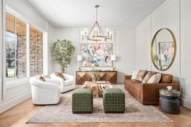 sitting room with a chandelier, recessed lighting, and a decorative wall