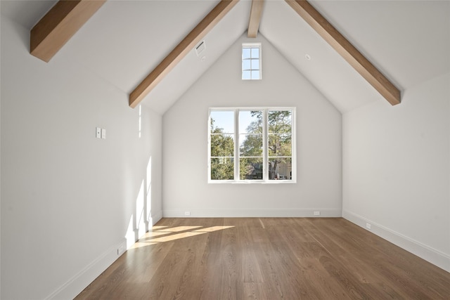 additional living space featuring vaulted ceiling with beams, baseboards, and wood finished floors