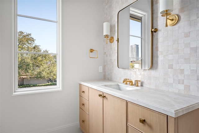 bathroom with decorative backsplash and vanity