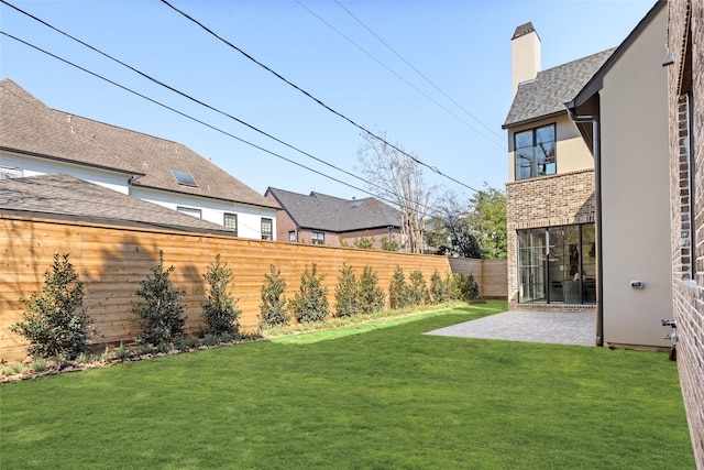 view of yard featuring a patio and a fenced backyard