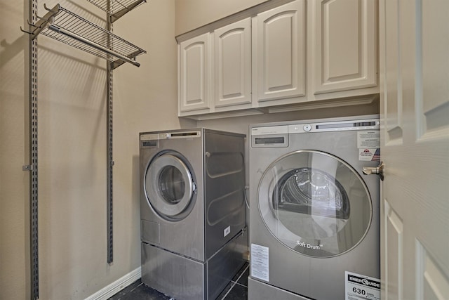 clothes washing area with cabinet space and washing machine and clothes dryer