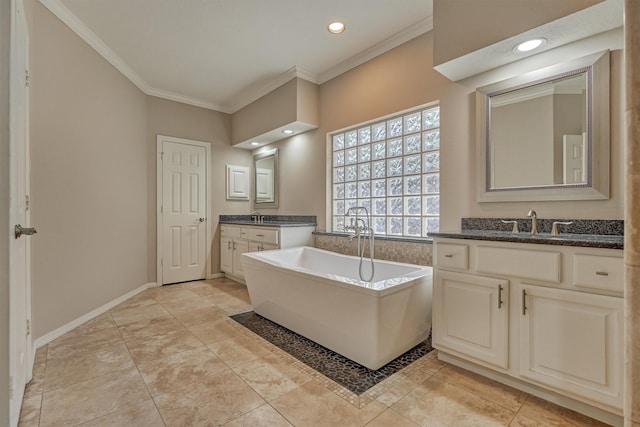 full bathroom with a sink, two vanities, baseboards, ornamental molding, and a soaking tub