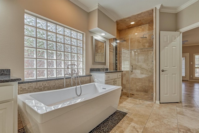 full bathroom with a stall shower, plenty of natural light, a freestanding bath, and crown molding