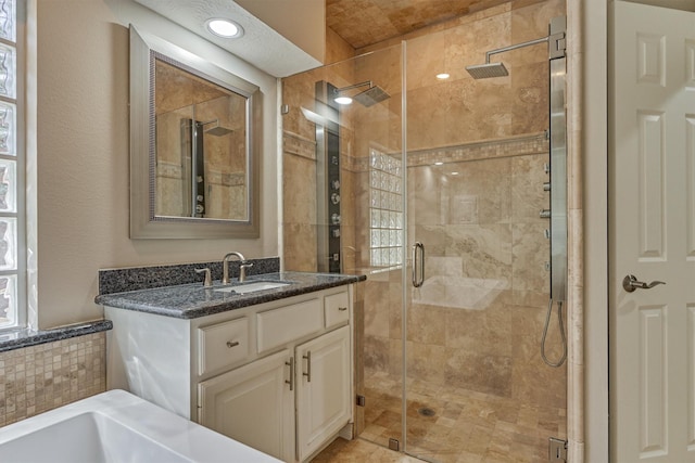 bathroom featuring a shower stall and vanity