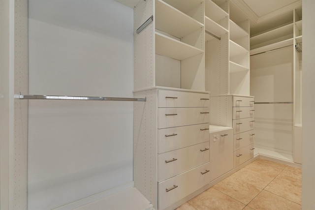 walk in closet with light tile patterned floors