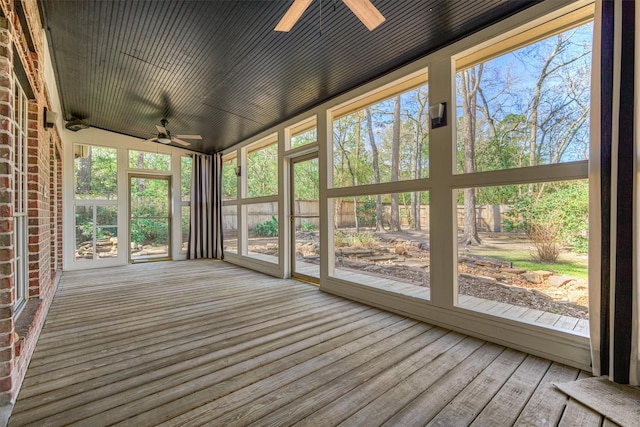 unfurnished sunroom with ceiling fan