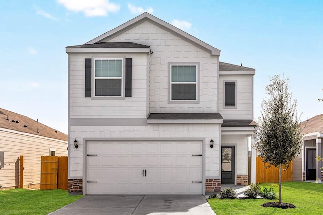 traditional-style home with concrete driveway, stone siding, an attached garage, fence, and a front lawn