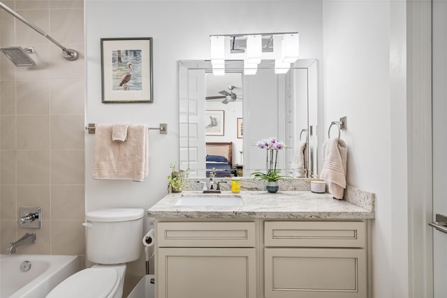 ensuite bathroom featuring a ceiling fan, toilet, ensuite bath, vanity, and shower / bathtub combination