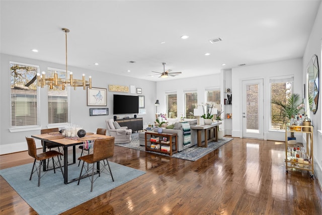 living area with recessed lighting, visible vents, wood finished floors, baseboards, and ceiling fan with notable chandelier