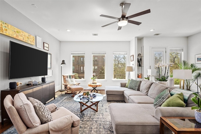 living area with recessed lighting, visible vents, and a healthy amount of sunlight