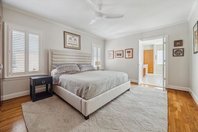 bedroom with multiple windows and wood finished floors