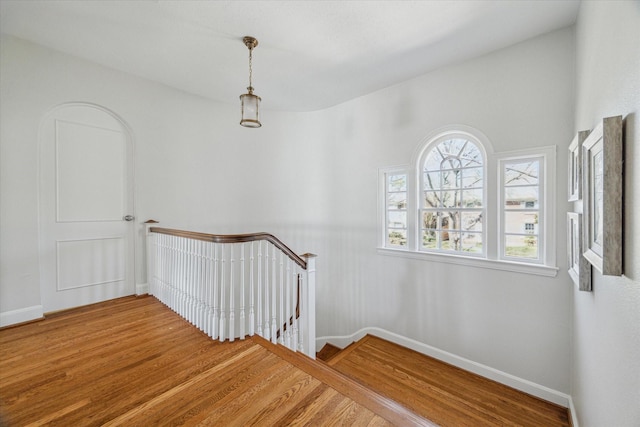 stairs featuring baseboards and wood finished floors