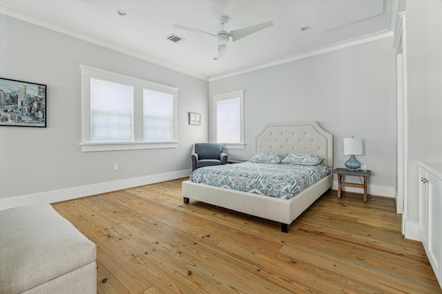 bedroom with a ceiling fan, baseboards, visible vents, light wood-style floors, and crown molding