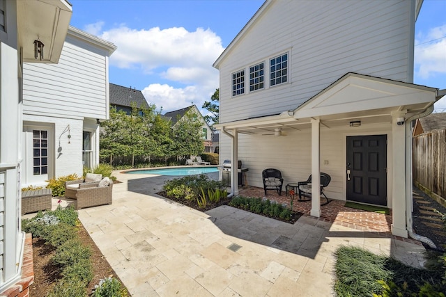 view of patio with grilling area, an outdoor living space, ceiling fan, a fenced backyard, and an outdoor pool