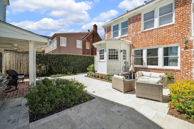 view of patio / terrace with outdoor lounge area, a ceiling fan, and fence