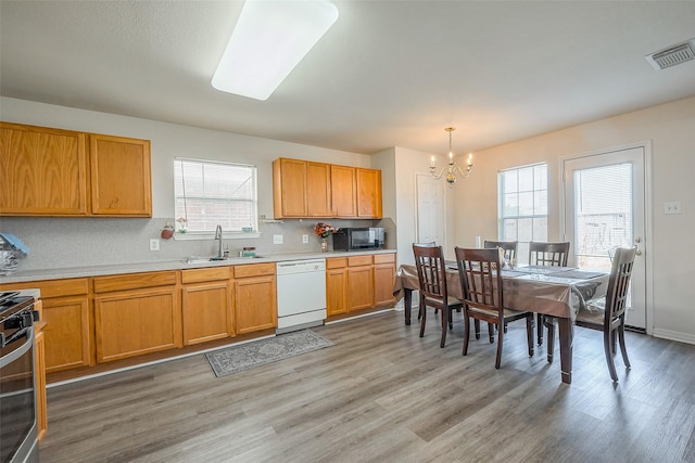 kitchen with black microwave, stainless steel gas range oven, a sink, visible vents, and dishwasher