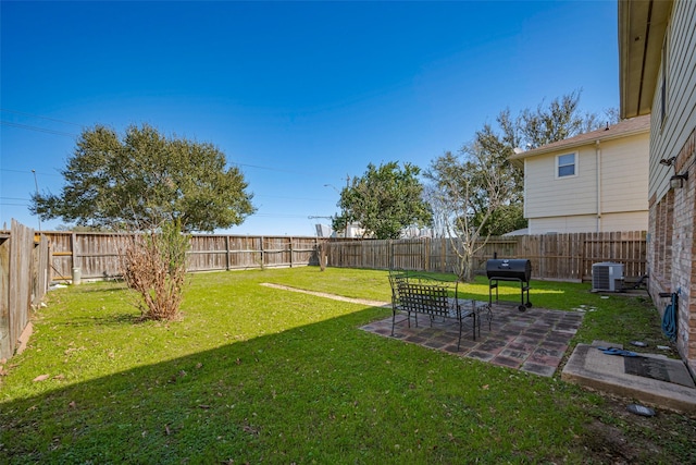 view of yard featuring a patio area, a fenced backyard, and central air condition unit