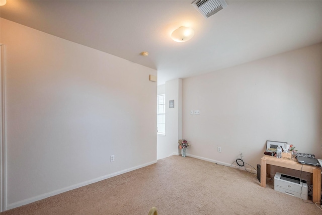 unfurnished room featuring carpet, visible vents, and baseboards