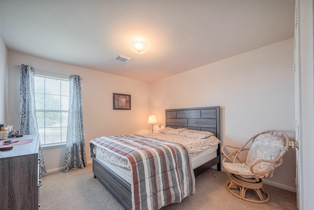 bedroom with baseboards, visible vents, and carpet flooring