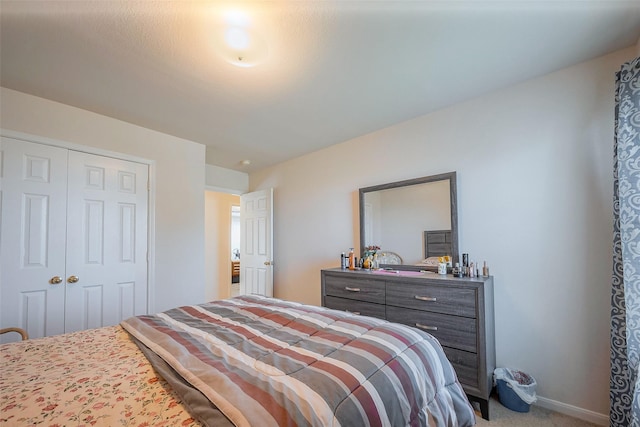 bedroom featuring a closet, carpet flooring, and baseboards