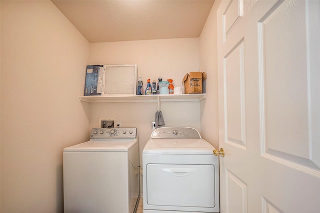 clothes washing area featuring laundry area and washer and dryer